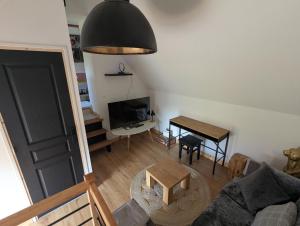 a living room with a couch and a table at Le Pigeonnier in Rosult