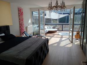 a bedroom with a bed and a bathroom with a tub at Eifelloft&Spa in Adenau +19 photos