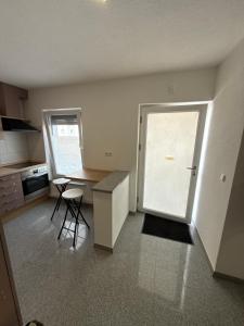 a kitchen with a door and a table and a counter at Team at Home Senden in Senden +12 photos