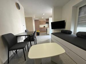 a living room with a table and a dining room at Team at Home Senden in Senden