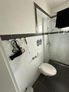 a bathroom with a white toilet and a shower at Team at Home Senden in Senden