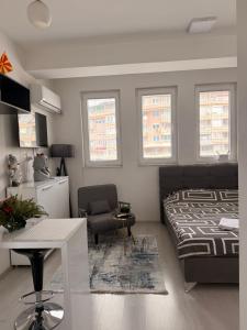 a bedroom with a bed and a table and a chair at M & M Apartment in Ohrid +22 photos