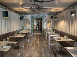 a dining room with tables and chairs and a corridor at La Terrazza di via Elisa in Lucca