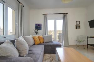 a living room with a couch and a table at Amethyst - holiday apartment in Likotinaréa
