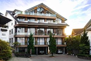 an apartment building with a lot of windows at Zenora Hillside Garden in Da Lat