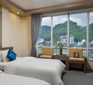 a hotel room with a bed and a large window at Catba Central Hotel 2 in Cat Ba