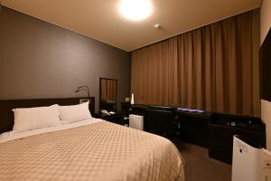 a hotel room with a bed and a desk at Hotel nanvan浜名湖 in Kosai +36 photos