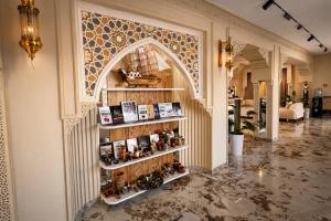 a room with a shelf with bottles on it at AMIR PLAZA hotel in Akmechetʼ