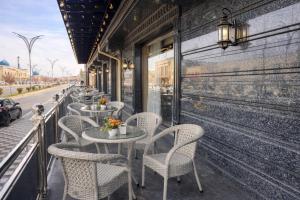 a row of tables and chairs on a balcony at AMIR PLAZA hotel in Akmechetʼ