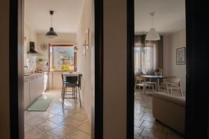 a kitchen and living room with a table and chairs at Hera Home B&B in Serra Pedace