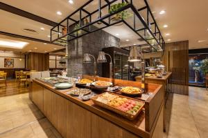 a buffet line in a restaurant with food on it at Hotel Keihan Tenmabashi in Osaka
