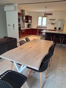 a wooden table and chairs in a kitchen at La Motte in La Motte