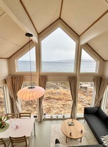 a living room with a view of the ocean at Steigen Cabin North in Steigen