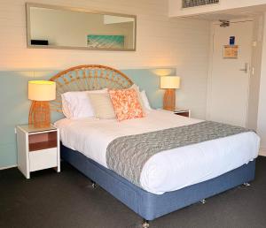 a bedroom with a large bed with two lamps at Marcoola Surf Air Hotel Room 2515 in Marcoola +19 photos