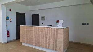 a reception desk in a room with a vase of flowers at Verdant Comfort Apartment in Moka +14 photos