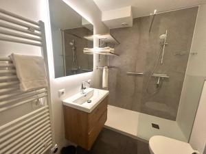 a bathroom with a sink and a shower at Prins Prachtig Amelander Kaap 97 in Hollum +13 photos