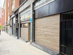a row of store fronts on a city street at Bilbao ROOMS & KITCHEN Zabalburu in Bilbao