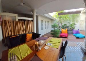 a living room with a wooden table and a couch at The Patio Yogya in Yogyakarta