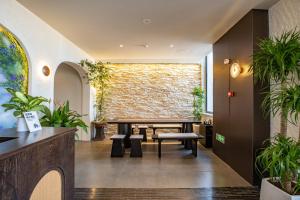 a room with a table and benches and a brick wall at Bay Four Seasons Castle Hotel in Weihai