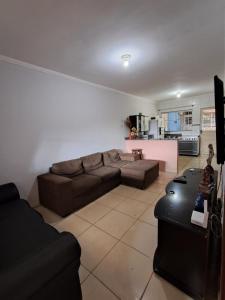 a living room with a couch and a kitchen at Recanto Campo Belo in Monte Sião