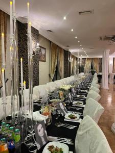 a long line of tables with plates of food at Dwór Kresowy in Radymno