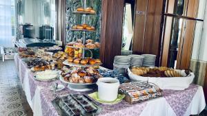 a table with a buffet of food on it at Hotel Villa Verde in San Mauro a Mare