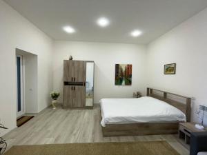 a bedroom with a bed and a cabinet in it at Sweet Home in Dilijan