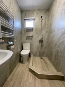a bathroom with a toilet and a sink at Sweet Home in Dilijan +27 photos