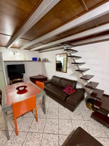 a living room with a couch and a staircase at Il ponte di vetro Home in Brindisi