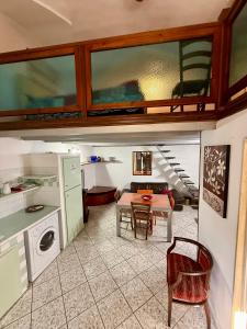 a kitchen with a table and a dining room at Il ponte di vetro Home in Brindisi