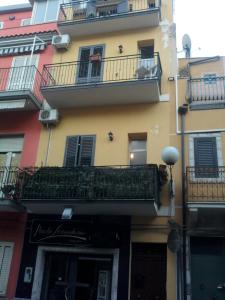 a building with balconies on the side of it at Lina House in Giardini Naxos