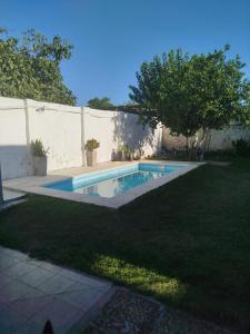 a swimming pool in a yard next to a fence at Tempo Suites in Córdoba