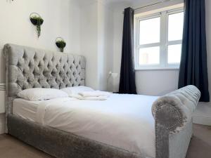 a bedroom with a large bed and a window at One bedroom Flat in Birmingham City Centre with free underground parking in Birmingham