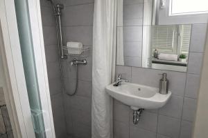 a bathroom with a sink and a shower with a mirror at Mobile House Sweet Dreams - Terme Čatež in Brežice