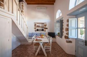 a home office with a table and a staircase at Theologos Houses in Grikos