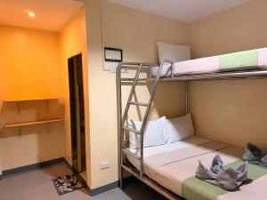 a bunk bed room with two bunk beds in it at Rain Haven Lodging House in Coron