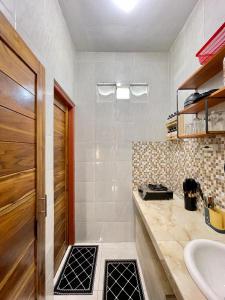 a bathroom with a sink and a toilet and a mirror at 1 BR Private Studio Apartment with Kitchen in Kerobokan +33 photos