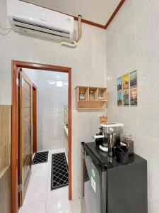 a kitchen with a refrigerator and a air conditioner at 1 BR Private Studio Apartment with Kitchen in Kerobokan