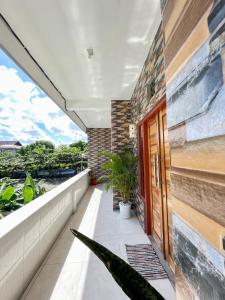 a balcony with a red door and plants at 1 BR Private Studio Apartment with Kitchen in Kerobokan