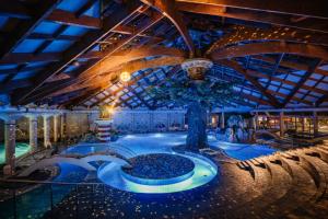 a large indoor pool with a tree in the middle at Mobile House Sweet Dreams - Terme Čatež in Brežice