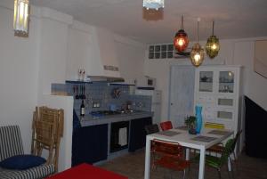 a kitchen with a table and chairs in a room at Villa stella di mare in Capitana +29 photos
