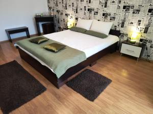 a bed with two pillows on it in a bedroom at Casa Mais Brașov Guesthouse with Free Parking in Braşov