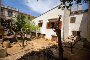 a white building with trees in front of it at El refugio de NaRo in Chella