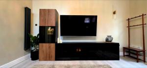 a living room with a large flat screen tv at Dabbagh Residence in Lees