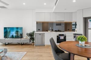 a kitchen and dining room with a table and chairs at CBD Luxury River View & Fireworks 1Bed Apt The One in Brisbane