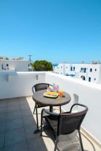a patio with a table and chairs on a balcony at Villa Andromeda in Amorgos +66 photos