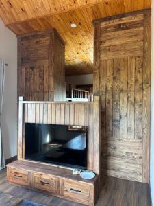 a large wooden entertainment center with a large television at R Chai in Countach Da