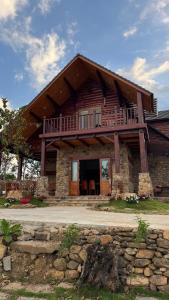 a large wooden house with a balcony on top at R Chai in Countach Da