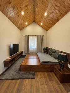 a large room with a bed and a television at R Chai in Countach Da
