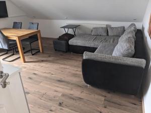 a living room with a couch and a table at Ferienwohnung Lang in Nittenau
